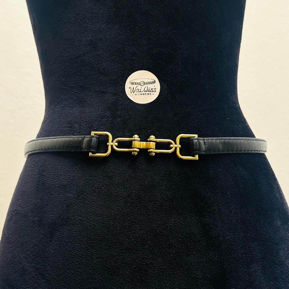 Black and gold leather belt with brass hardware and gold accents